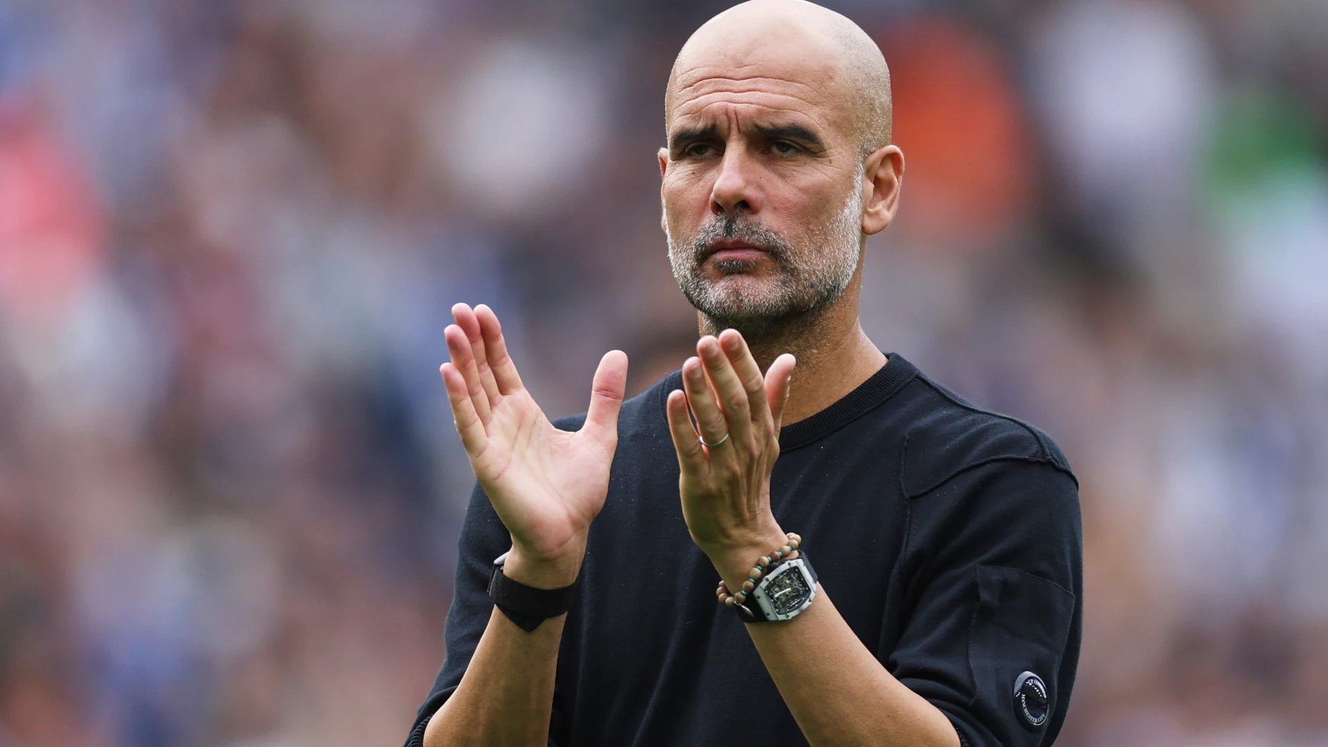Manchester City's head coach Pep Guardiola applauds supporters after the English Premier League soccer match between Brighton and Hove Albion and Manchester City at the Falmer stadium in Brighton, England, Sunday, Aug. 31, 2025. (AP Photo/Ian Walton)