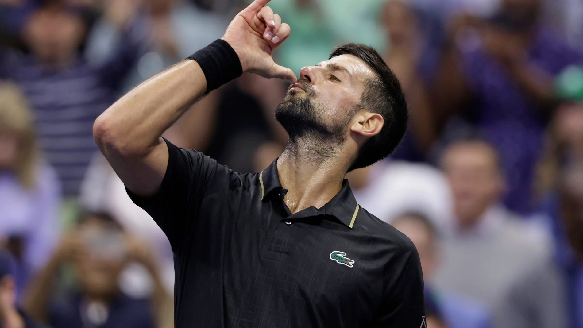 Novak Djokovic, of Serbia, reacts after defeating Taylor Fritz, of the United States, during the quarterfinal round of the U.S. Open tennis championships, Tuesday, Sept. 2, 2025, in New York. (AP Photo/Adam Hunger)