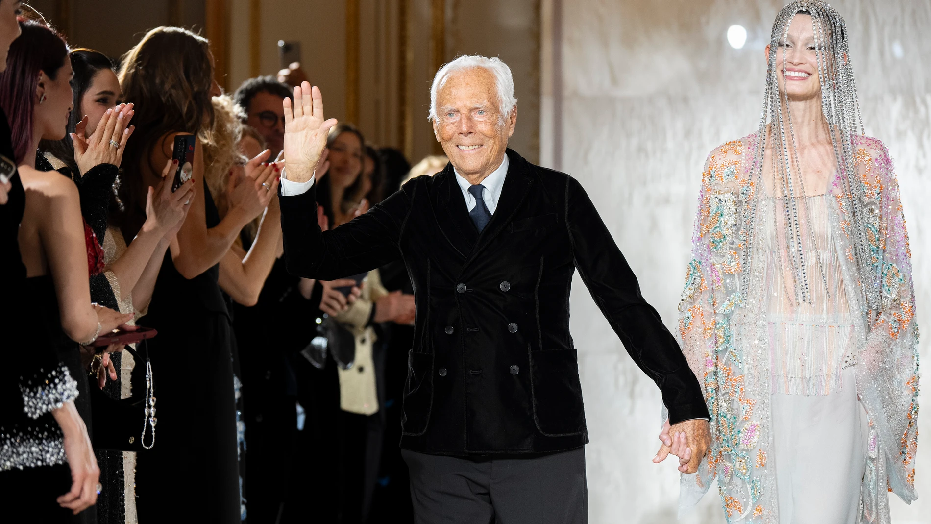 FILE - Giorgio Armani waves at the end of the Giorgio Armani Prive Haute Couture Spring Summer 2025 collection in Paris, Jan. 28, 2025. (AP Photo/Lewis Joly, File)