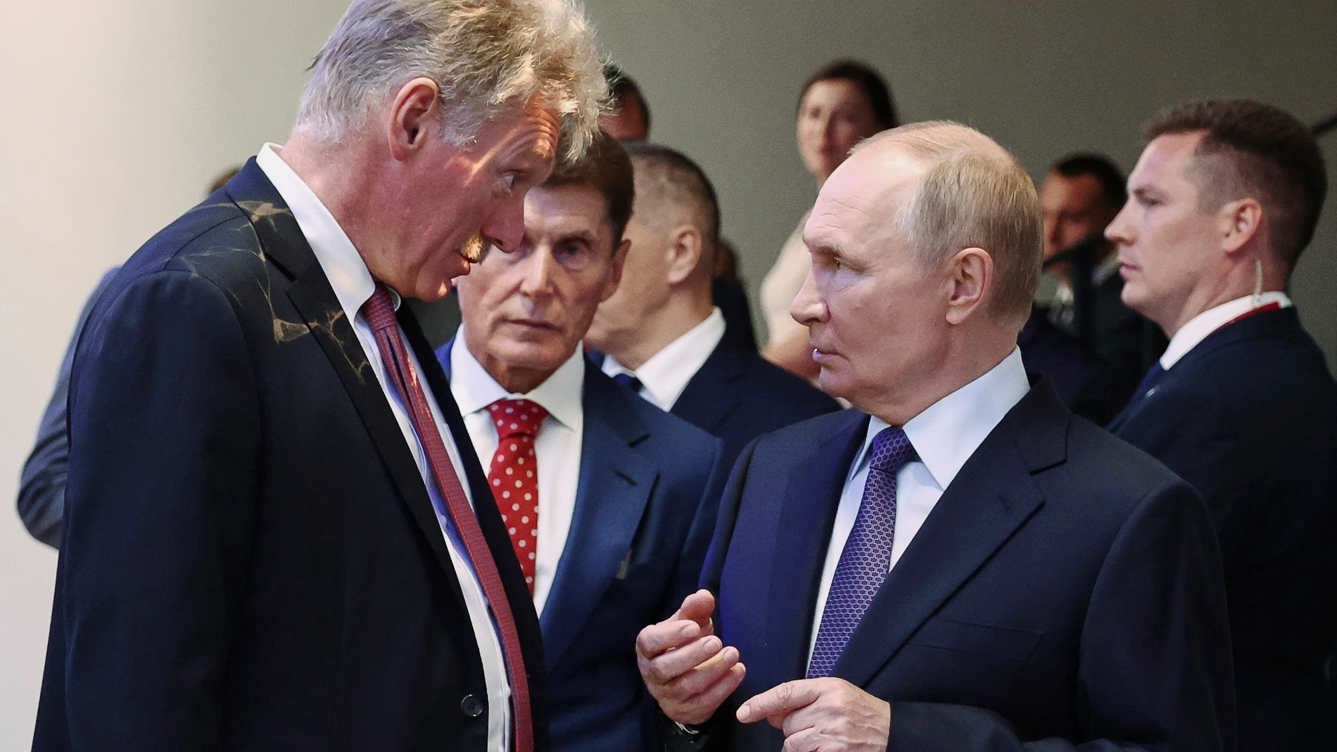 Russian President Vladimir Putin, right, speaks with Kremlin spokesman Dmitry Peskov while visiting the interactive exhibition dedicated to the 155th Separate Guards Orders of Suvorov and Zhukov Kursk Marine Brigade named after Hero of Russia Mikhail Gudkov, at the branch of the National Center "Russia" in Vladivostok, Russia, on Thursday, Sept. 4, 2025. (Alexander Kazakov, Sputnik, Kremlin Pool Photo via AP)