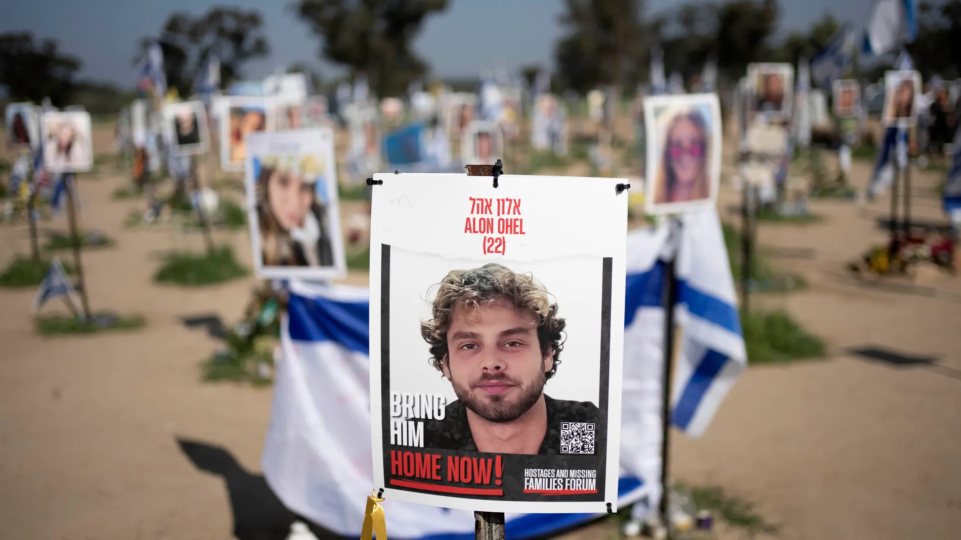 FILE - A poster depicting Israeli hostage Alon Ohel is displayed in Re'im, southern Israel, at the Gaza border, Feb. 26, 2024, at a memorial site for the Nova music festival site where he was kidnapped by Hamas on Oct. 7, 2023. (AP Photo/Maya Alleruzzo, File)
