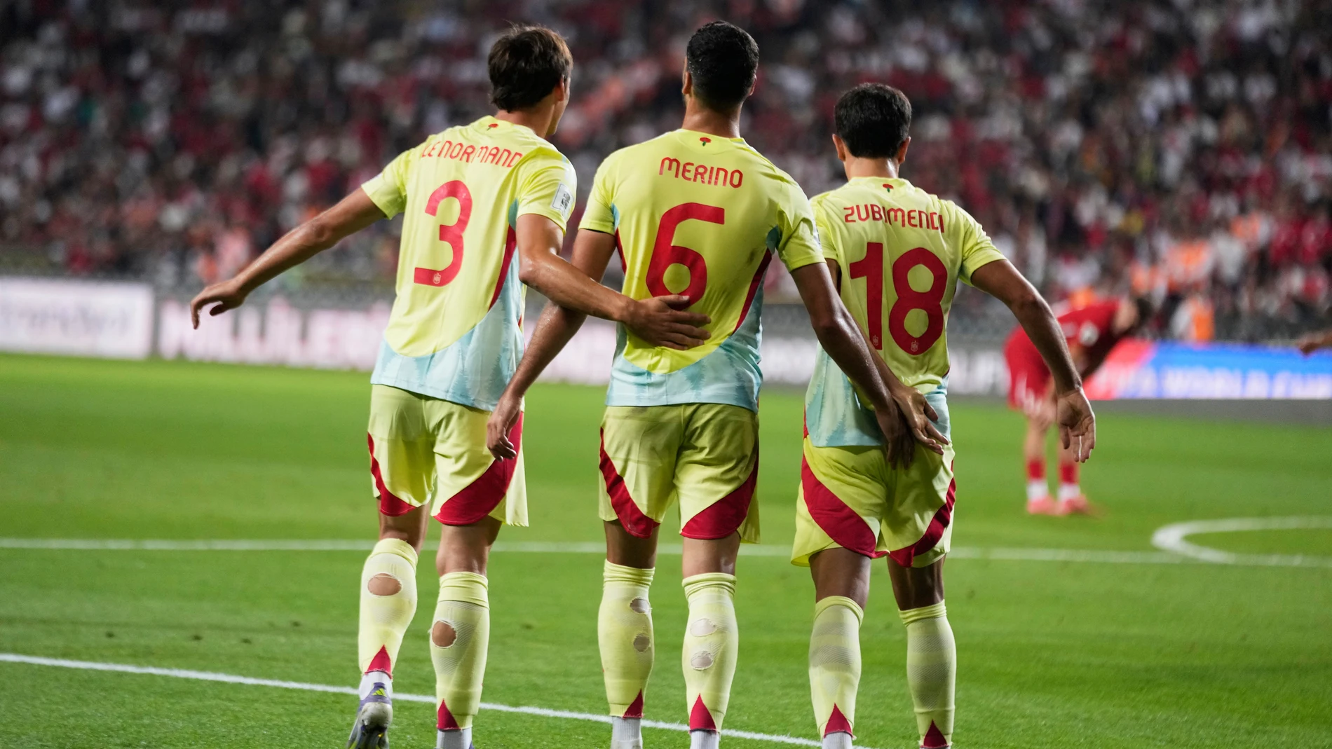 Spain's Robin Le Normand, left, Mikel Merino, center, and Martín Zubimendi celebrate after Pedri scored their side's 6th goal during a World Cup qualifying round Group E soccer match between Turkey and Spain at Konya Buyuksehir stadium, in Konya, Turkey, Sunday, Sept. 7, 2025. (AP Photo/Khalil Hamra)