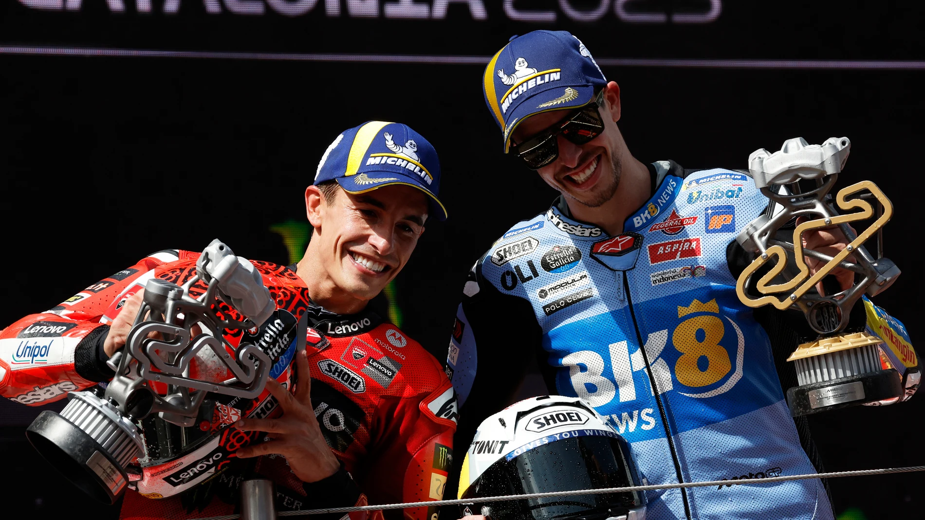 Race winner Spain's rider Alex Marquez of the BK8 Gresini Racing MotoGP, right, poses on the podium with second placed Spain's rider Marc Marquez of the Ducati Lenovo Team after the MotoGP race of the Grand Prix of Catalonia at the Catalunya racetrack in Montmelo, just outside of Barcelona, Spain, Sunday, Sept. 7, 2025. (AP Photo/Joan Monfort)