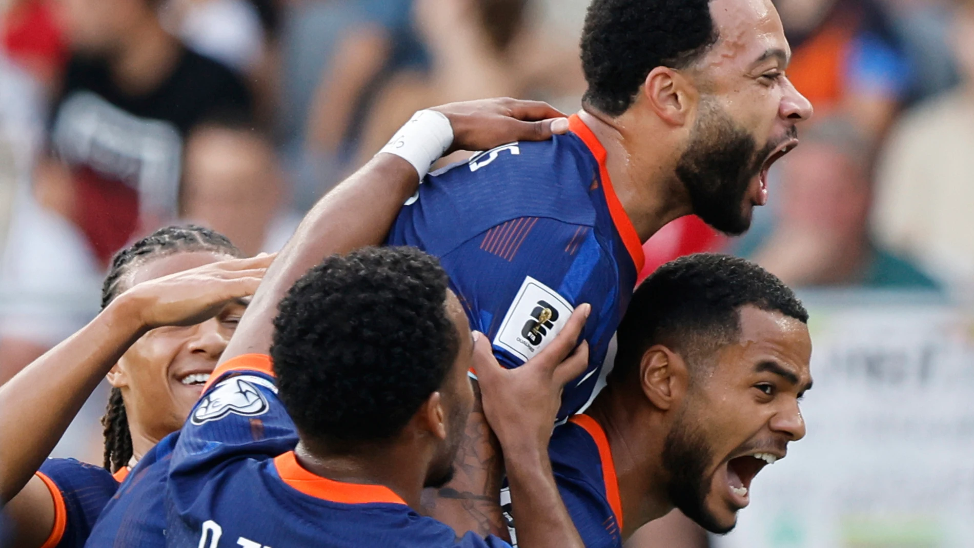 Dutch players celebrate their side's first goal scored by Memphis Depay, top, during the World Cup qualifying soccer match between Lithuania and Netherlands at Darius and Girenas stadium in Kaunas, Lithuania, Sunday, Sept. 7, 2025. (AP Photo/Mindaugas Kulbis)