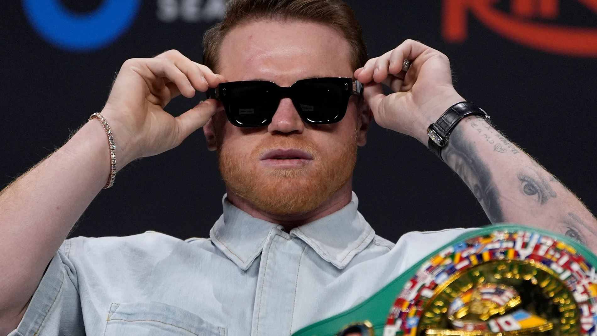 FILE - Canelo Alvarez adjusts his glasses during a news conference June 27, 2025, in Las Vegas. (AP Photo/John Locher, File)