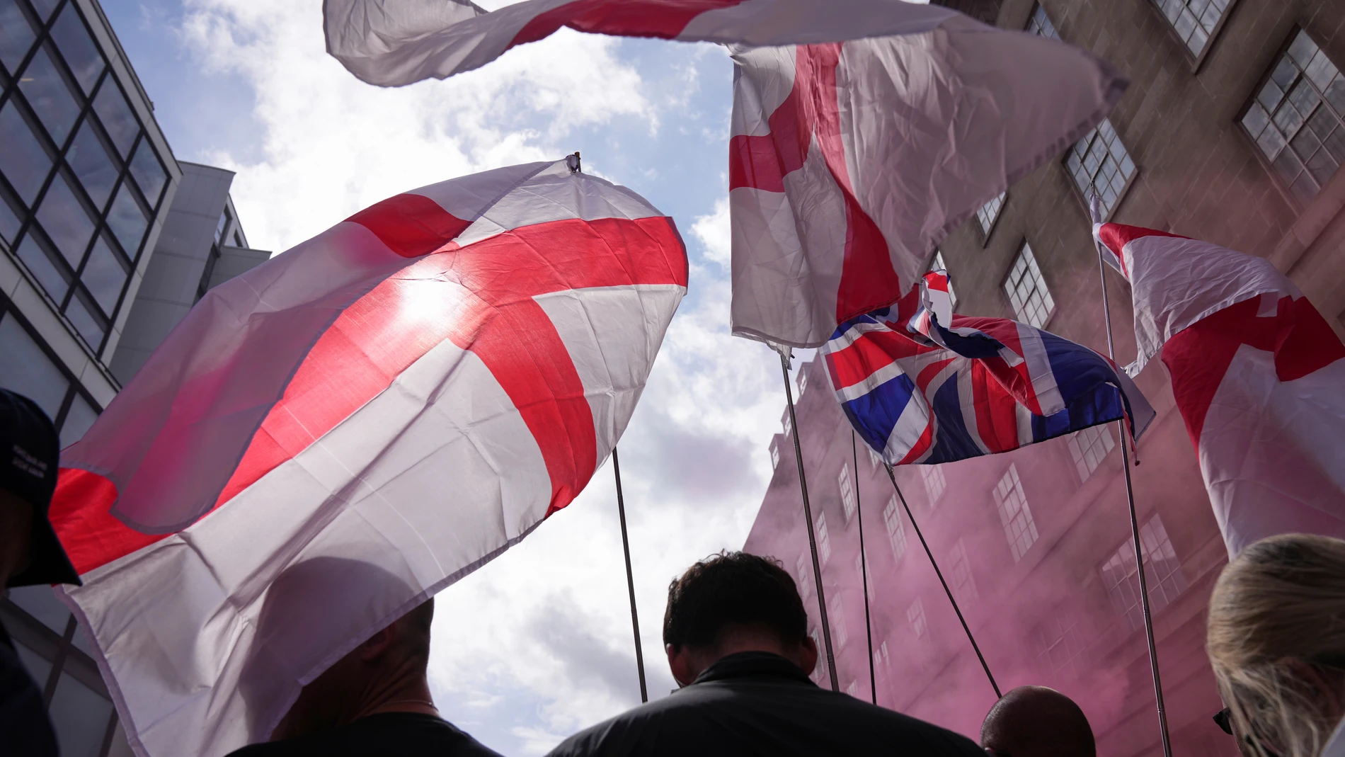 Demonstrators carry England and Union Jack flags during a Tommy Robinson-led Unite the Kingdom march and rally in London, Saturday Sept. 13, 2025. (AP Photo/Joanna Chan)