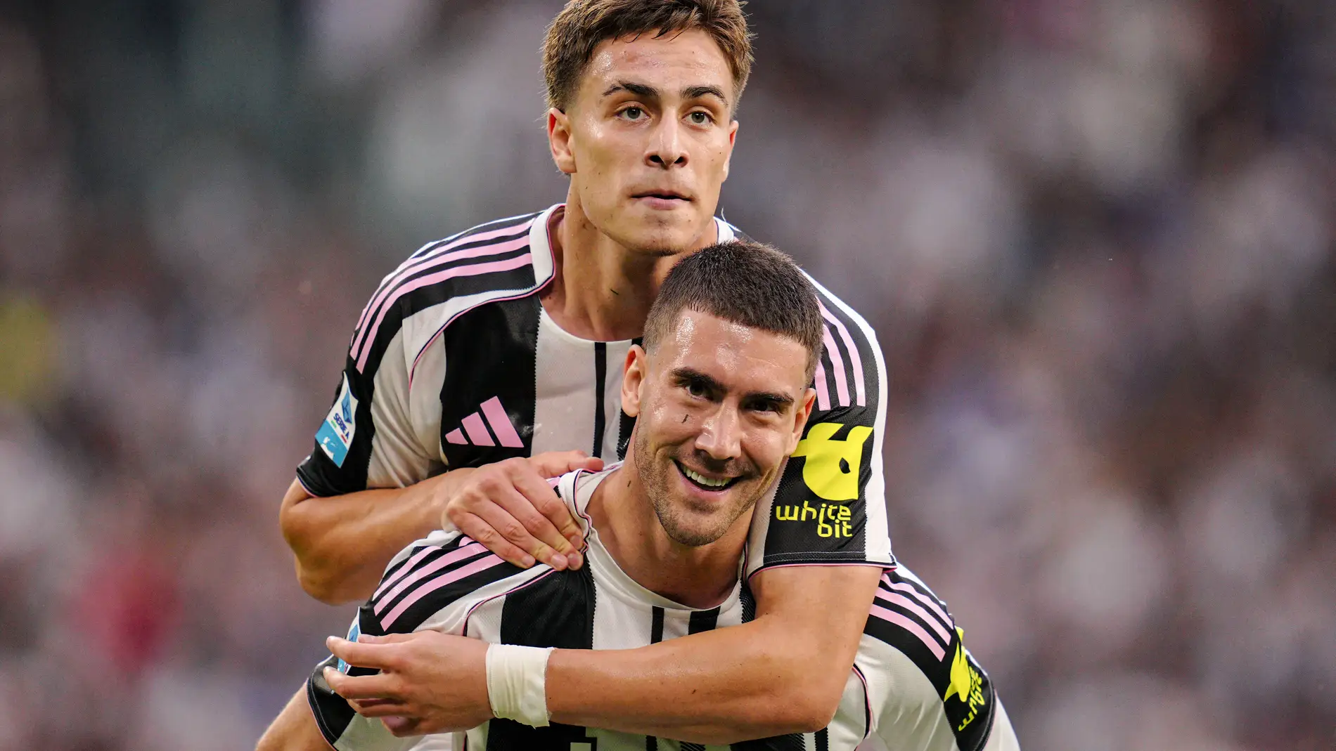 Juventus' Kenan Yildiz, top, celebrates with Dusan Vlahovic after scoring during the Serie A soccer match between Juventus and Inter at the Allianz Stadium in Turin, Italy, Saturday, Sept. 13, 2025. (Marco Alpozzi/LaPresse via AP)