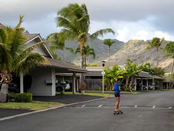 US Hawaiian School Admissions Challenge Kapua Ong skateboards near her home in Honolulu, on Thursday, Sept. 11, 2025. (AP Photo/Mengshin Lin)