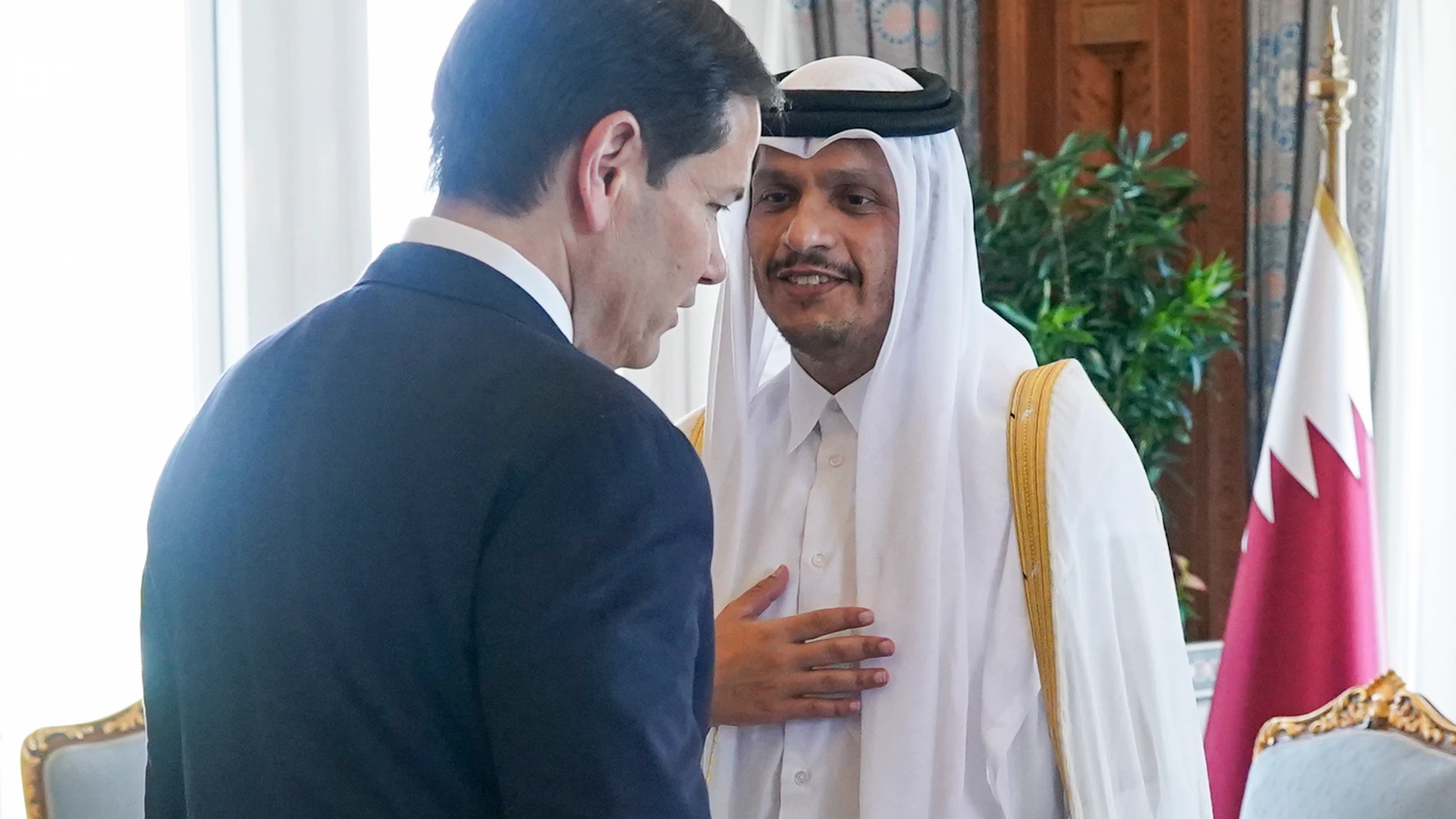 Qatar's Prime Minister and Minister for Foreign Affairs Sheikh Mohammed bin Abdulrahman bin Jassim Al-Thani greets U.S. Secretary of State Marco Rubio, back to camera, at Amiri Diwan, in Doha, Qatar, Tuesday, Sept. 16, 2025. (Nathan Howard/Pool Photo via AP)