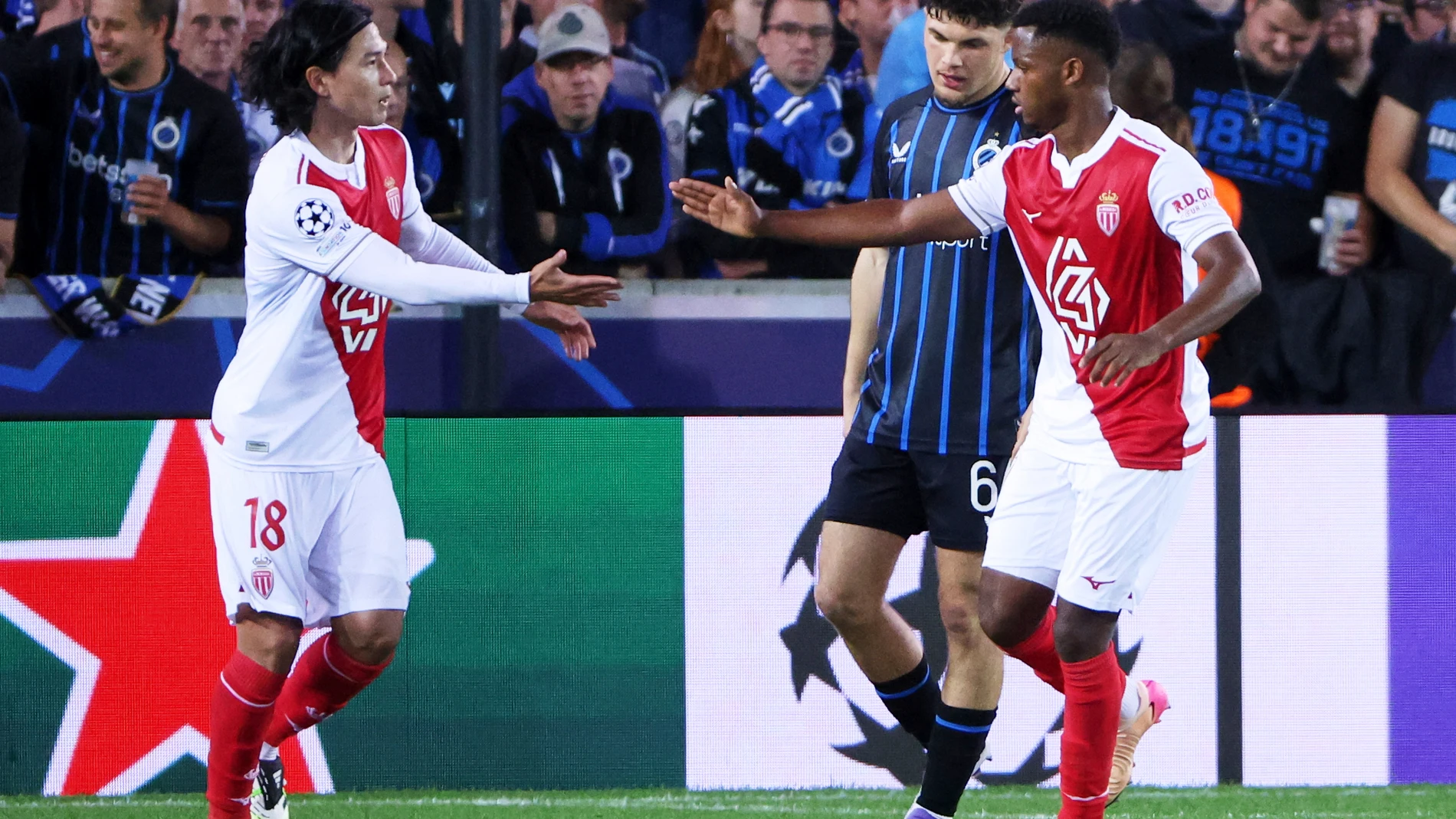Monaco's Ansu Fati, right, is congratulated by Monaco's Takumi Minamino after scoring his sides first goal during the Champions League opening phase soccer match between Club Brugge and Monaco at the Jan Breydel Stadium in Bruges, Belgium, Thursday, Sept. 18, 2025. (AP Photo/Omar Havana)