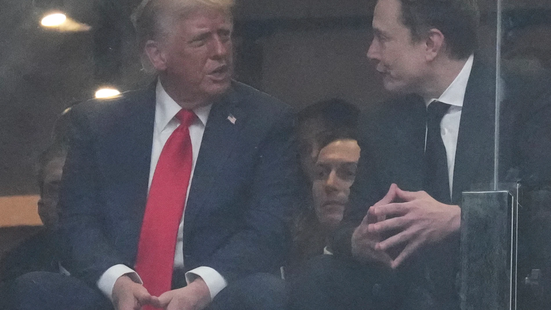 President Donald Trump and Elon musk talk during a memorial for Charlie Kirk, Sunday, Sept. 21, 2025, at State Farm Stadium in Glendale, Ariz. (AP Photo/Ross D. Franklin)