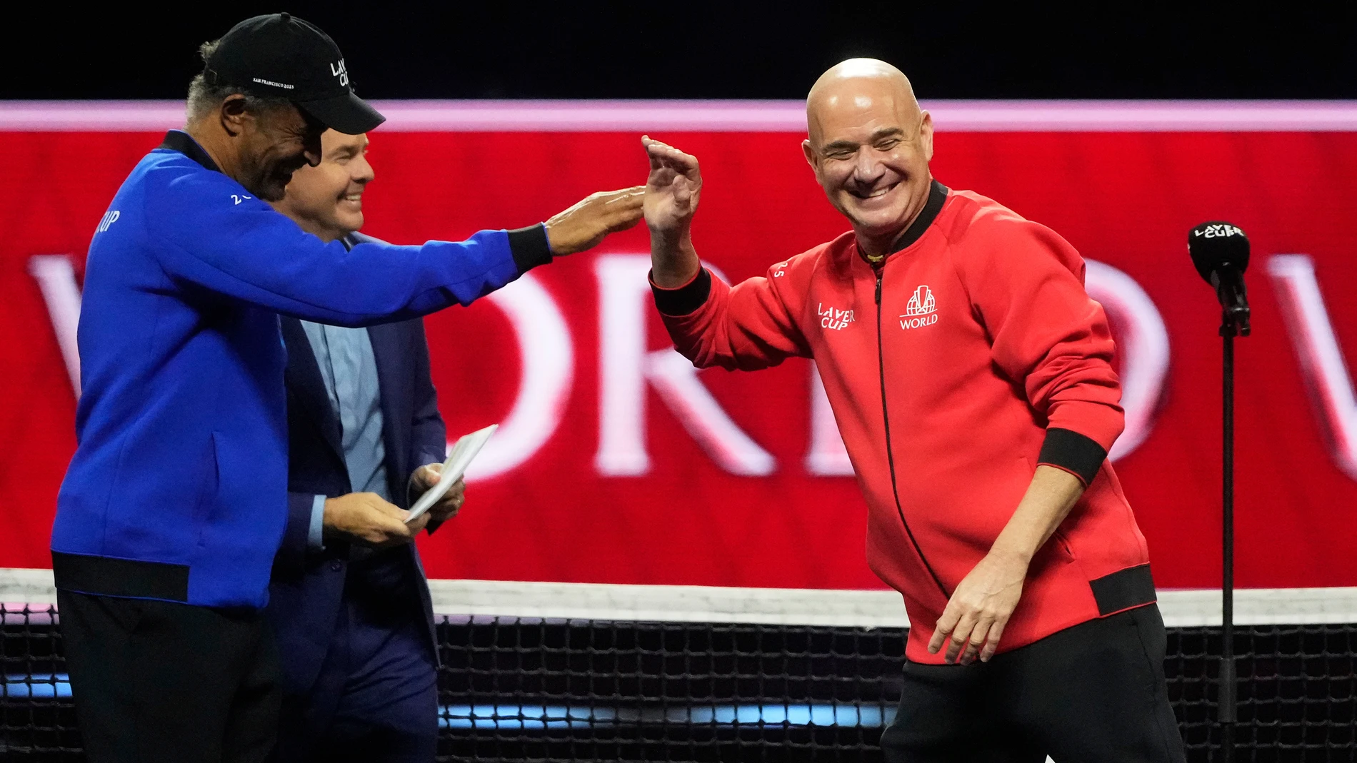 Team Europe captain Yannick Noah, left, is congratulates Team World captain Andre Agassi after Team World defeated Team Europe on the third day to win the Laver Cup tennis tournament in San Francisco, Sunday, Sept. 21, 2025. (AP Photo/Jeff Chiu)