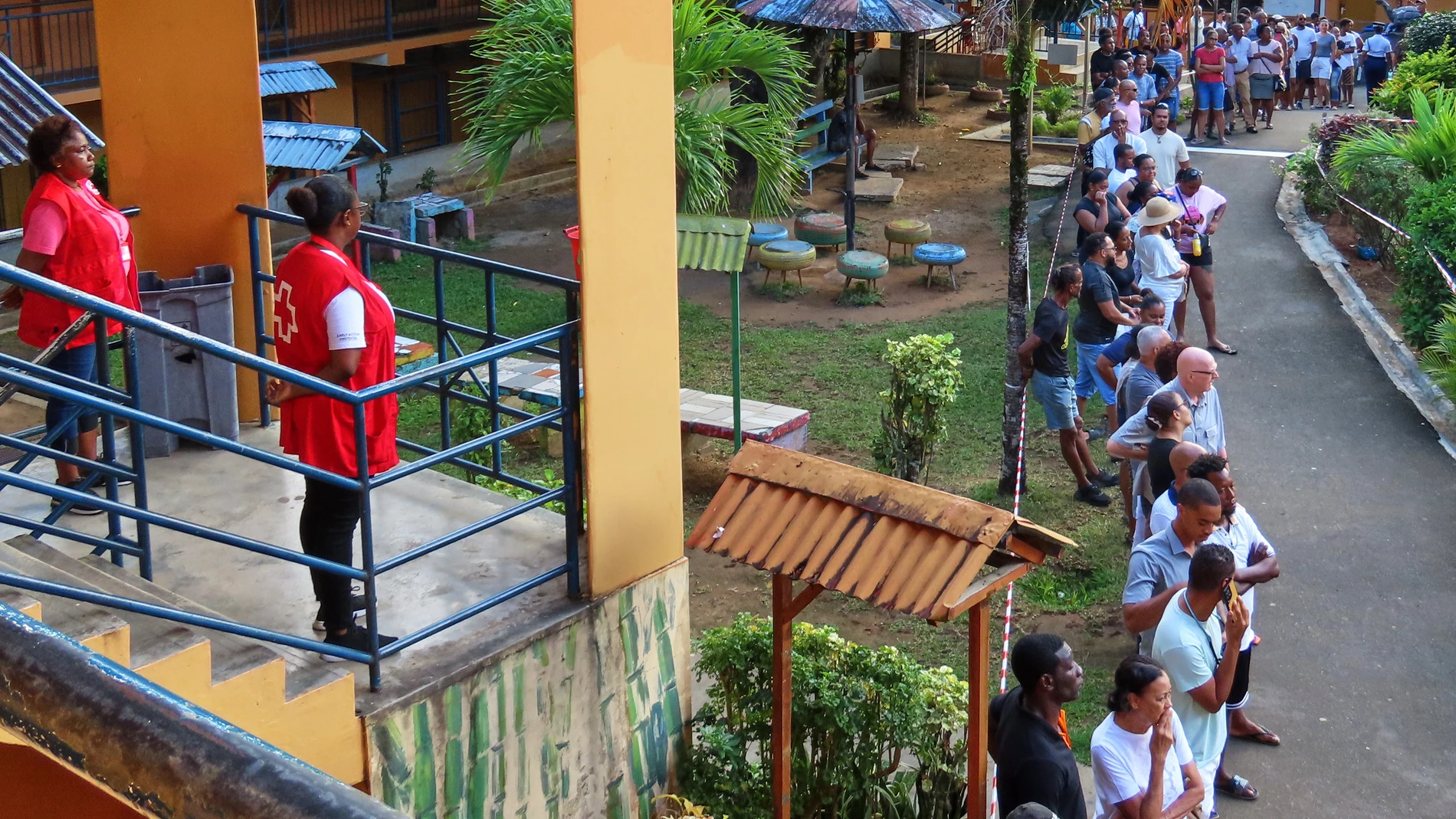 People line up to cast their votes at Beau Vallon Secondary School in Beau Vallon, Seychelles, on Saturday, Sep. 27, 2025. (AP Photo/Emilie Chetty)