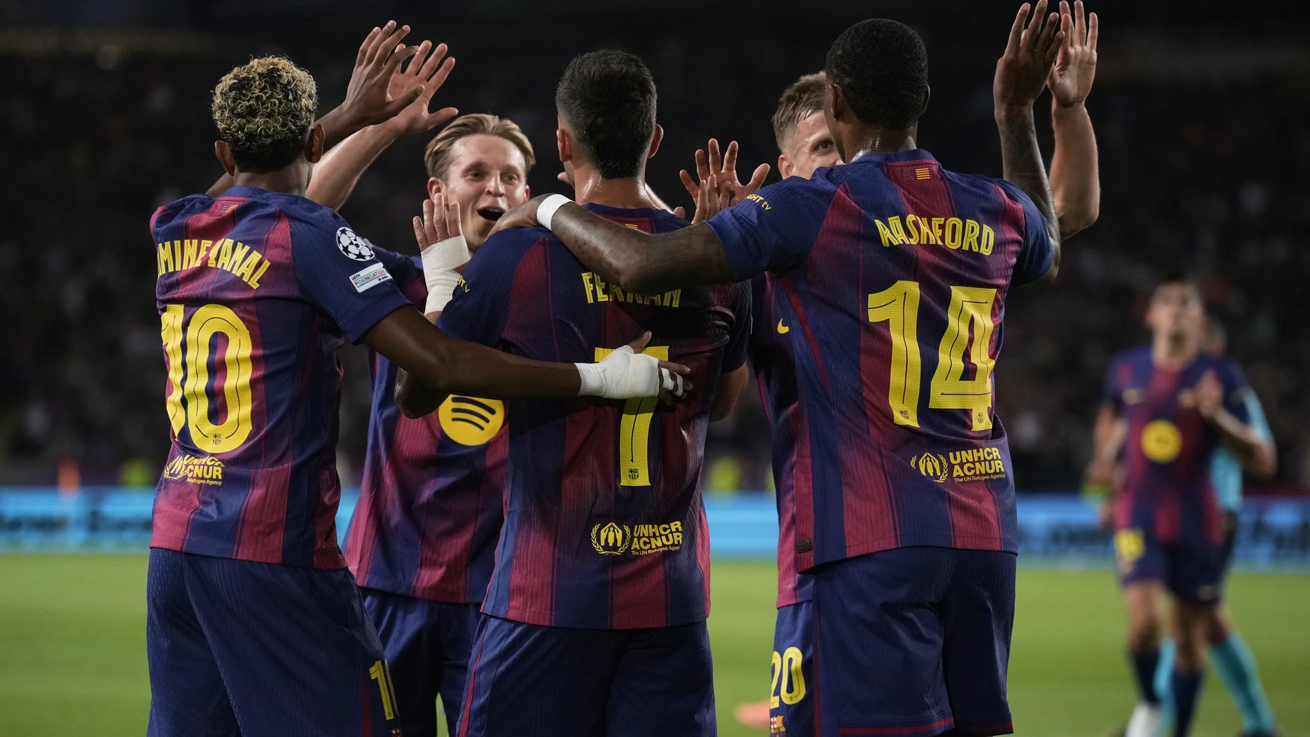 Barcelona's Ferran Torres, center, celebrates after scoring his side's first goal during the Champions League opening phase soccer match between Barcelona and Paris Saint-Germain at the Lluis Companys Olympic Stadium in Barcelona, Spain, Wednesday, Oct.1, 2025. (AP Photo/Emilio Morenatti)