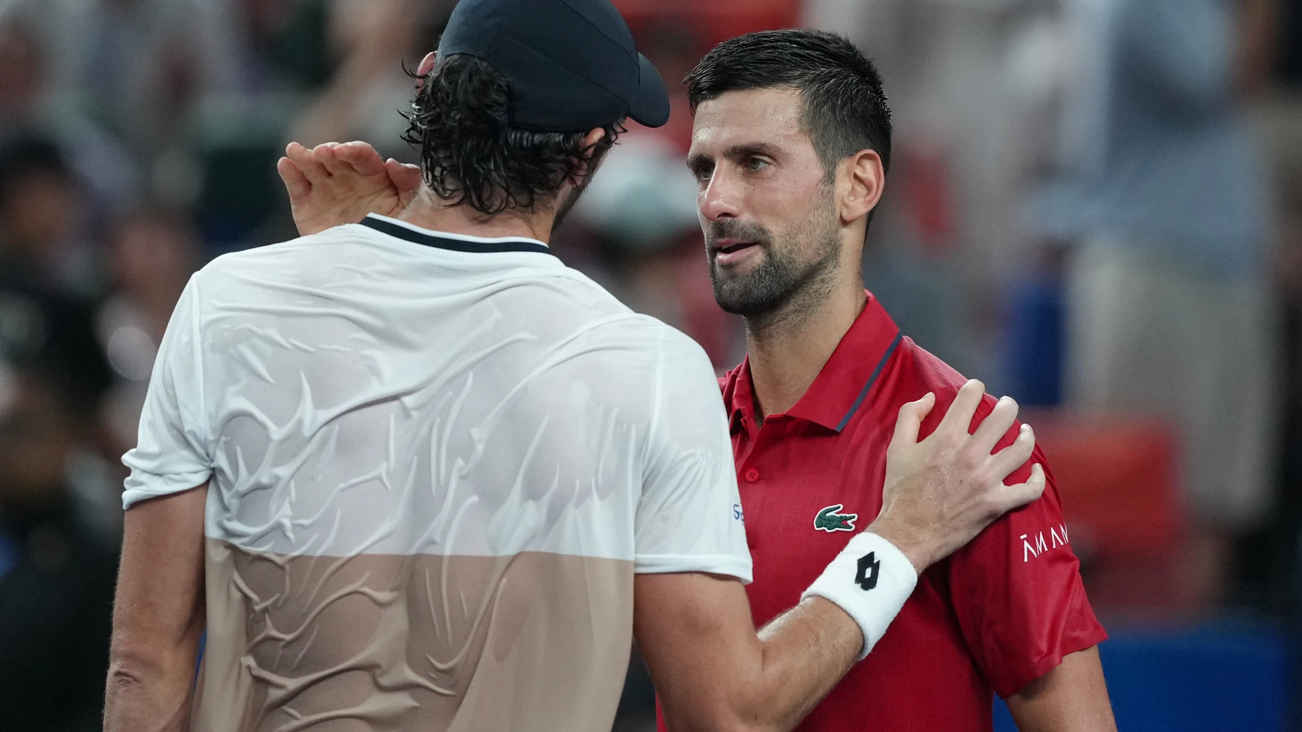 Valentin Vacherot of Monaco, left, is greeted by Novak Djokovic of Serbia after the former won in their men's singles semifinal match of the Shanghai Masters tennis tournament at Qizhong Forest Sports City Tennis Center, in Shanghai, China, Saturday, Oct. 11, 2025. (AP Photo/Andy Wong)