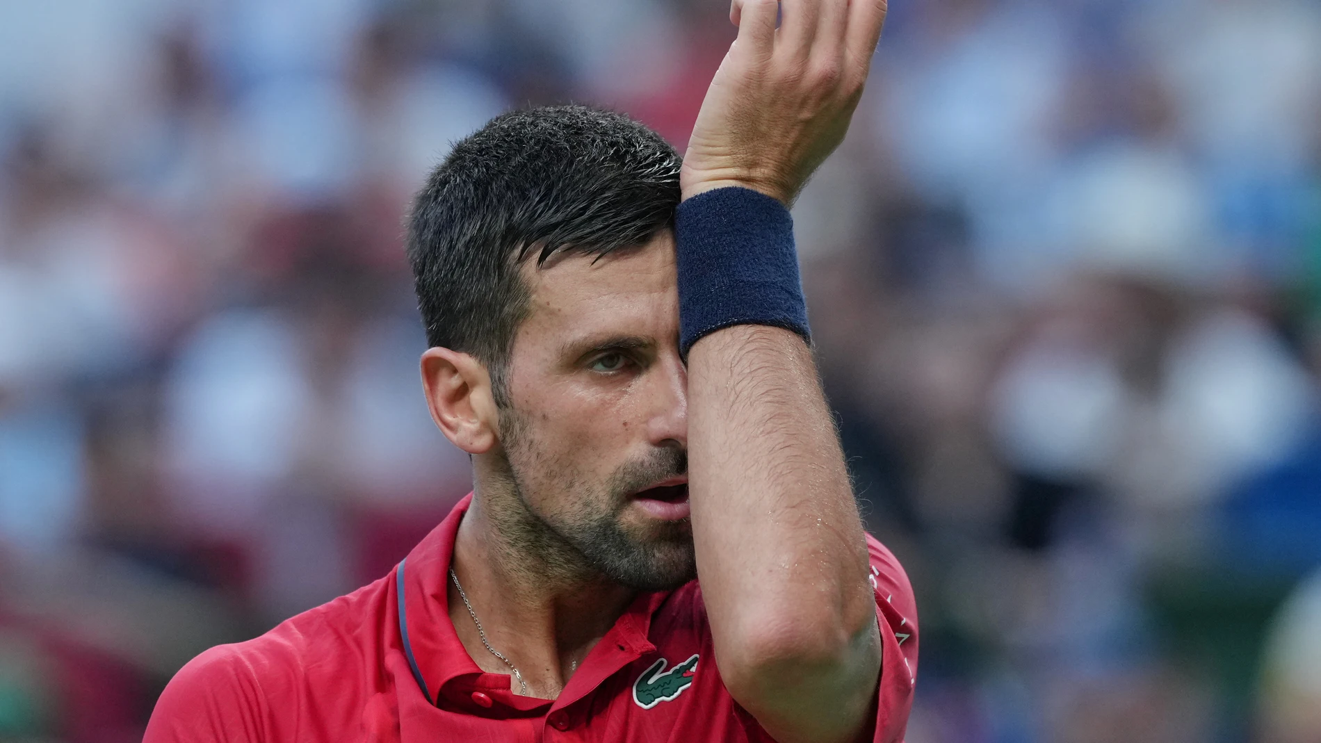 Novak Djokovic of Serbia reacts as he plays with Valentin Vacherot of Monaco during the men's singles semifinal match of the Shanghai Masters tennis tournament at Qizhong Forest Sports City Tennis Center, in Shanghai, China, Saturday, Oct. 11, 2025. (AP Photo/Andy Wong)