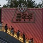 People ride an escalator next to a Douyin logo in Beijing, China. The Douyin app is the Chinese counterpart of TikTok. 