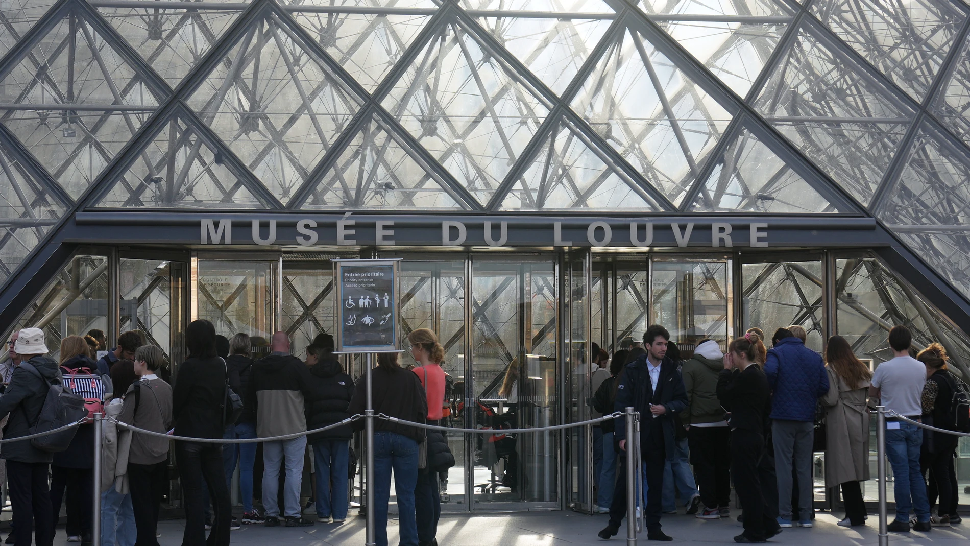 Visitors queue to enter the Louvre museum three days after historic jewels were stolen in a daring daylight heist, Wednesday, Oct. 22, 2025 in Paris. (AP Photo/Thibault Camus)