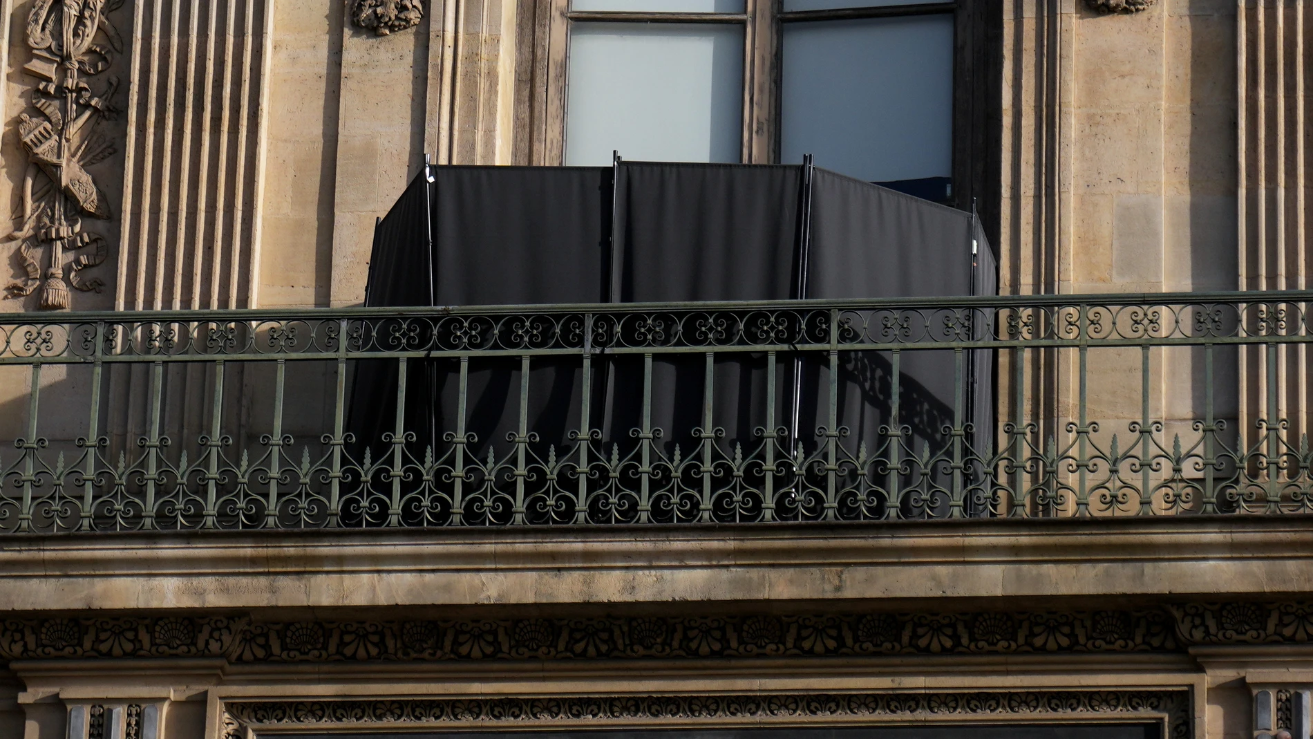 A black curtain hides the window where thieves entered the Louvre museum, three days after historic jewels were stolen in a daring daylight heist, Wednesday, Oct. 22, 2025 in Paris. (AP Photo/Thibault Camus)