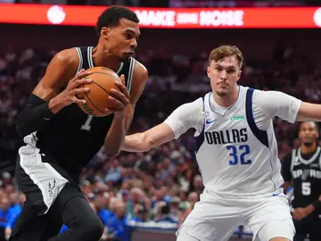 Spurs Mavericks Basketball San Antonio Spurs forward Victor Wembanyama (1) drives against Dallas Mavericks forward Cooper Flagg (32) during the first half of an NBA basketball game in Dallas, Wednesday, Oct. 22, 2025. (AP Photo/LM Otero)