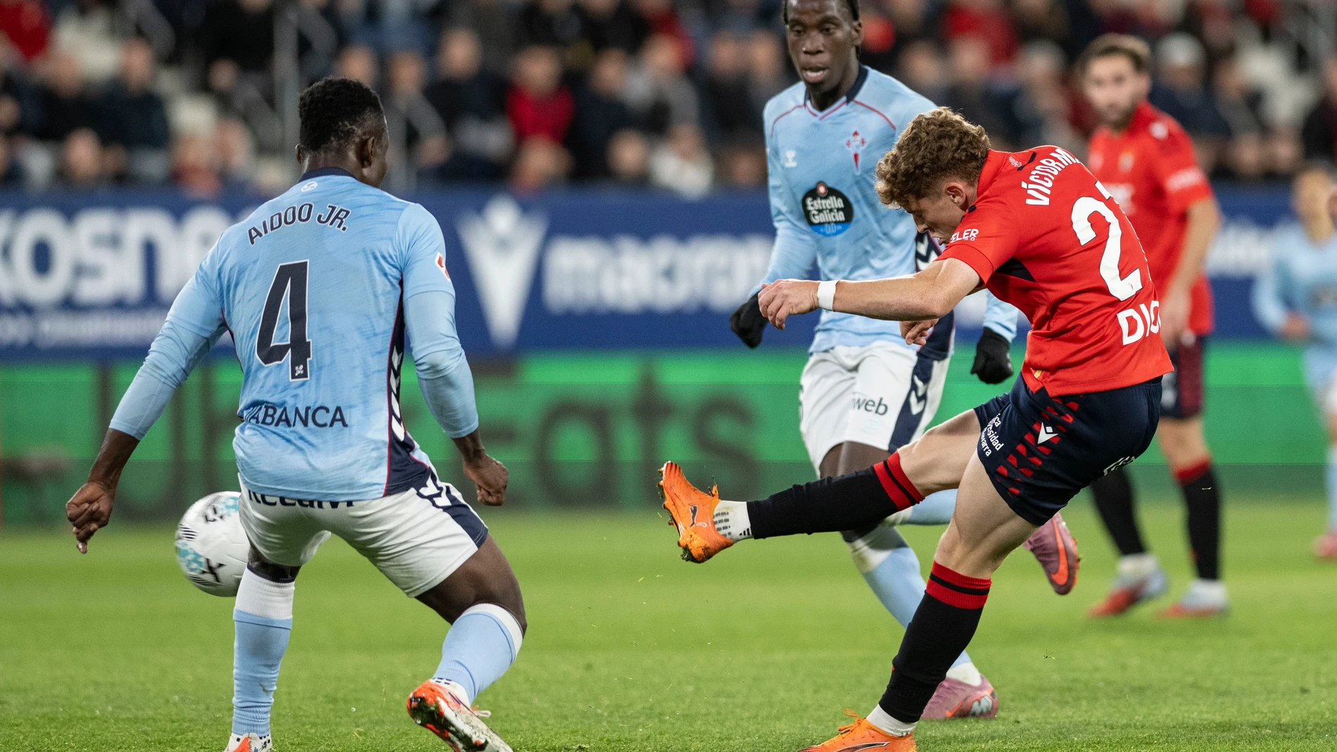 PAMPLONA, 26/10/2025.- El centrocampista de Osasuna Víctor Muñoz (d) chuta ante Joseph Aidoo (i), del Celta, durante el partido de LaLiga de fútbol que CA Osasuna y Celta de Vigo disputan este domingo en el estadio de El Sadar, en Pamplona. EFE/Iñaki Porto