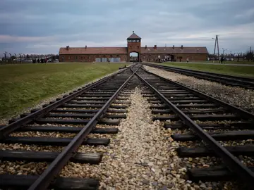 Germany Holocaust Compensation FILE - The railway tracks where hundred thousands of people arrived to be directed to the gas chambers inside the former Nazi death camp of Auschwitz Birkenau, or Auschwitz II, are pictured in Oswiecim, Poland, on Dec. 7, 2019. (AP Photo/Markus Schreiber, File)