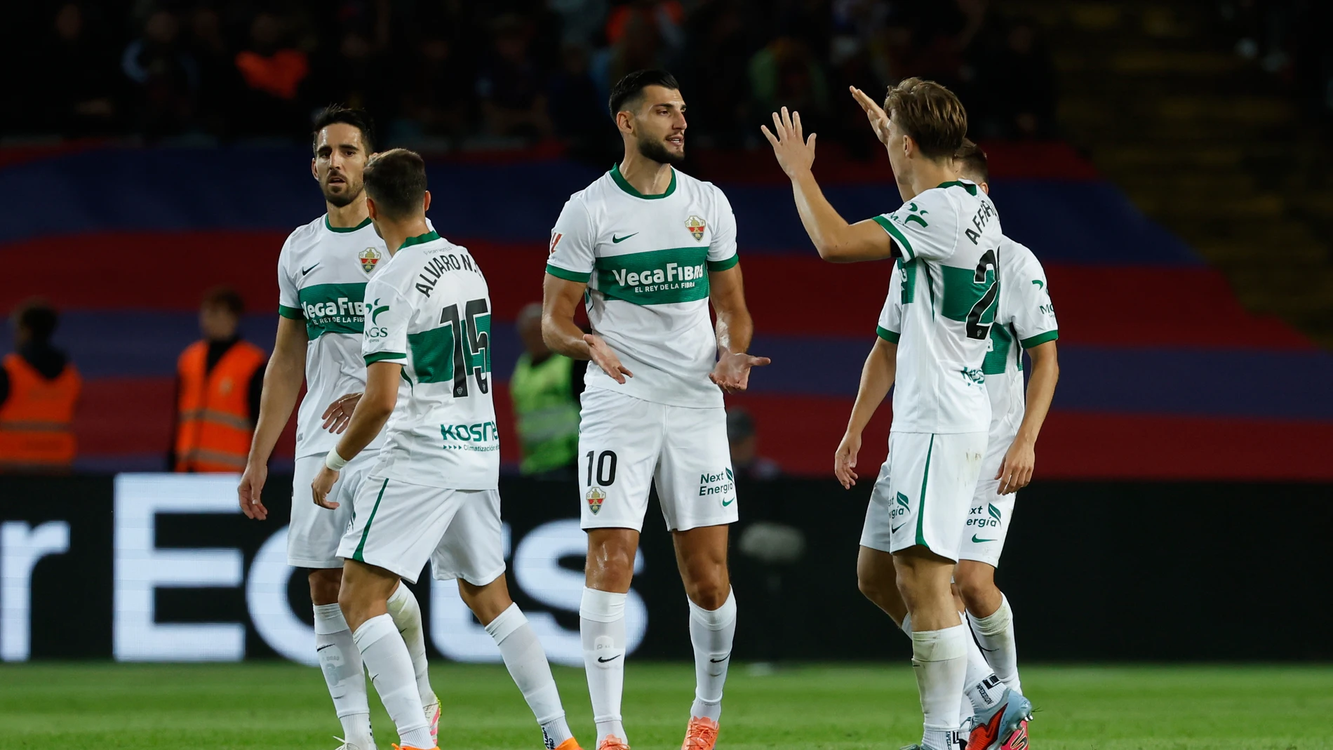 Elche's Rafa Mir, center, celebrates after scoring his side's opening goal during a Spanish La Liga soccer match between FC Barcelona and Elche CF in Barcelona, Spain, Sunday, Nov. 2, 2025. (AP Photo/Joan Monfort)