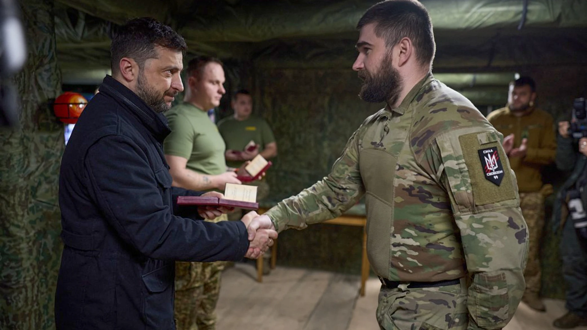 In this photo provided by the Ukrainian Presidential Press Office, Ukrainian President Volodymyr Zelenskyy, left, awards servicemen near the frontline city of Pokrovsk, Donetsk region, Ukraine, Tuesday, Nov. 4, 2025. (Ukrainian Presidential Press Office via AP)