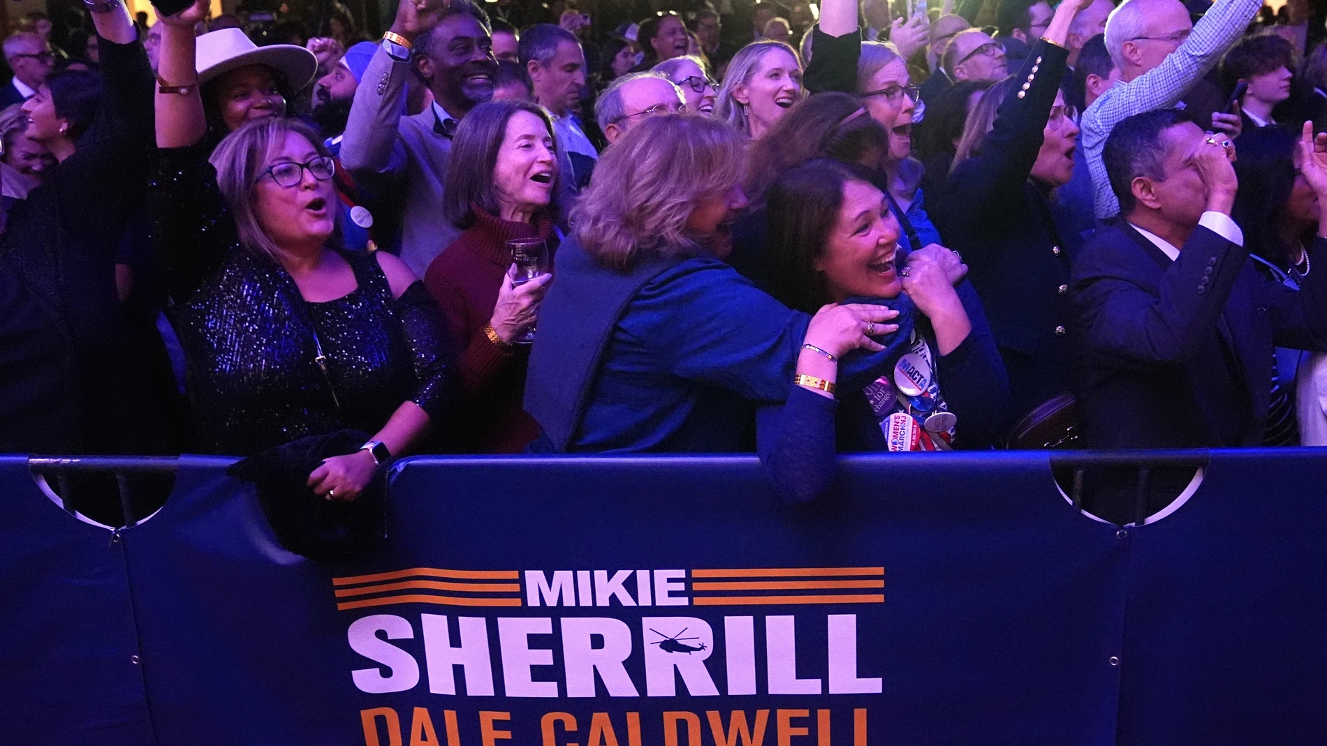 Supporters at New Jersey Democratic gubernatorial candidate Mikie Sherrill's election night party cheer as early results are seen in East Brunswick, N.J., Tuesday, Nov. 4, 2025. (AP Photo/Matt Rourke)