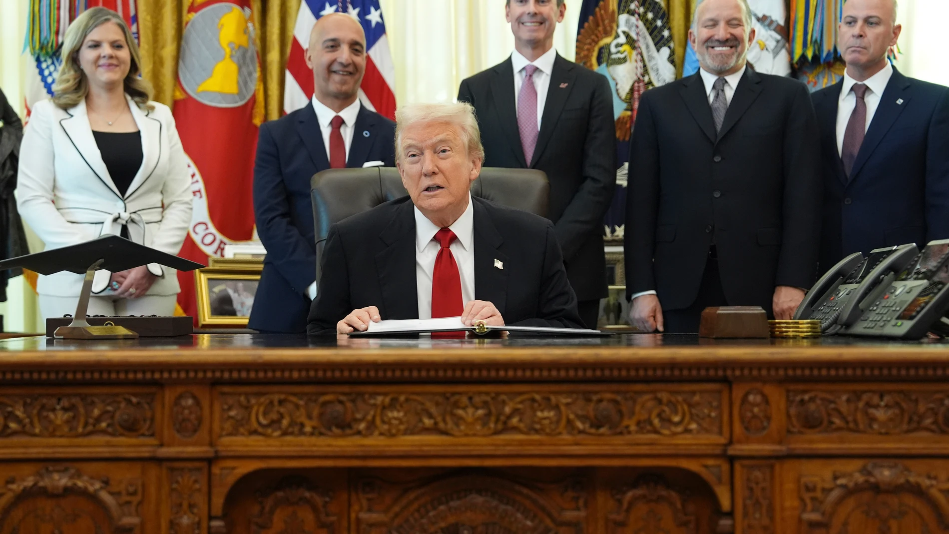 President Donald Trump speaks as Heidi Overton, deputy director of the White House Domestic Policy Council, from left, Novo Nordisk President and CEO Mike Doustdar, Eli Lilly CEO David Ricks, Commerce Secretary Howard Lutnick and David Moore, president of Novo Nordisk Inc., listen during an event about drug prices, Thursday, Nov. 6, 2025, in the Oval Office of the White House in Washington. (AP Photo/Evan Vucci)