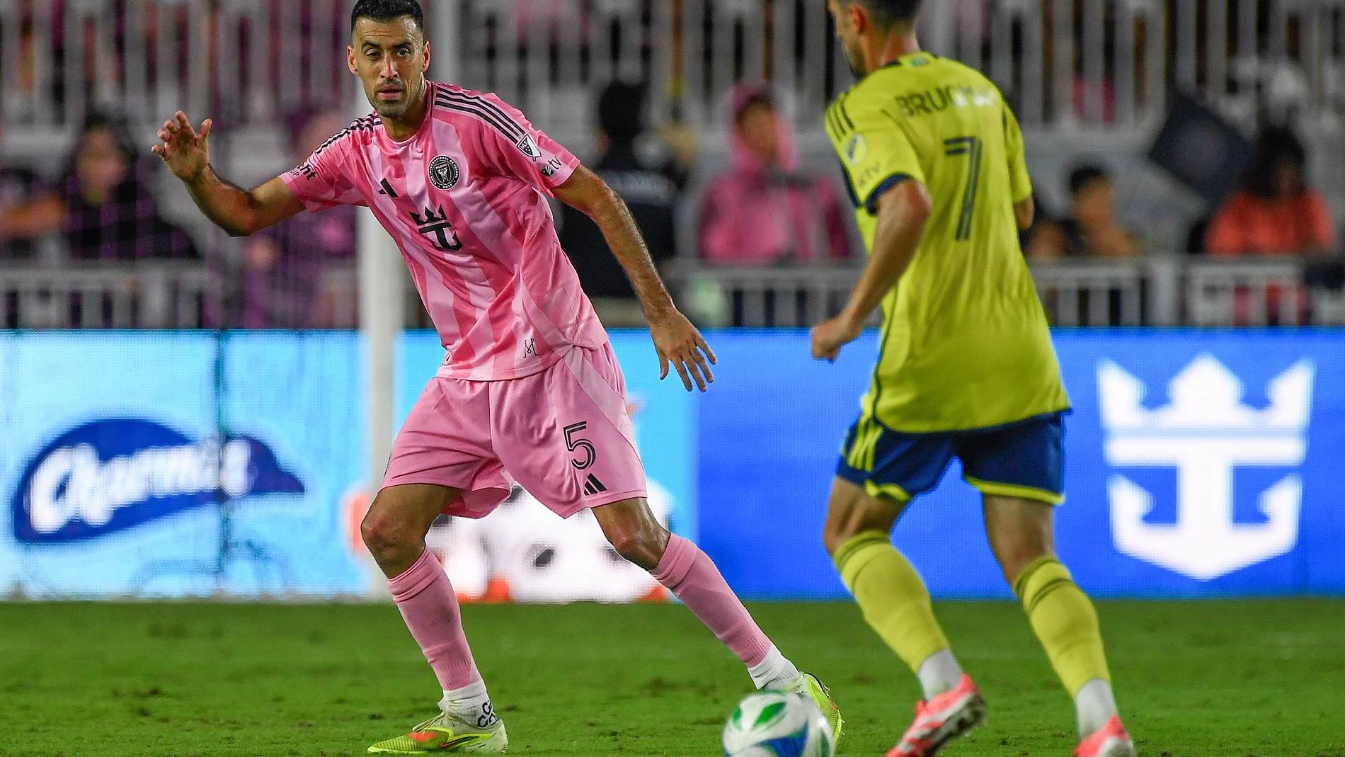 Inter Miami midfielder Sergio Busquets (5) defends Nashville SC midfielder Gastón Brugman (7) during the second half of Game 3 in the first round of MLS soccer's Western Conference playoffs in Fort Lauderdale, Fla., Nov. 8, 2025. (AP Photo/Michael Laughlin)
