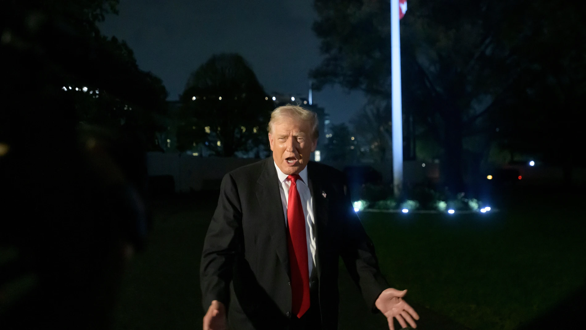 FILE - President Donald Trump talks with reporters upon his arrival at the White House in Washington, Nov. 9, 2025. (AP Photo/Rod Lamkey, Jr., File)