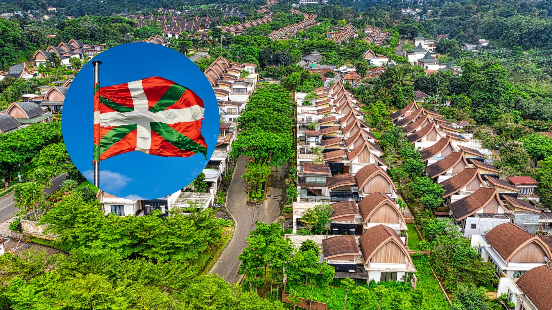 Imagen de varios chalets junto a una bandera del País Vasco