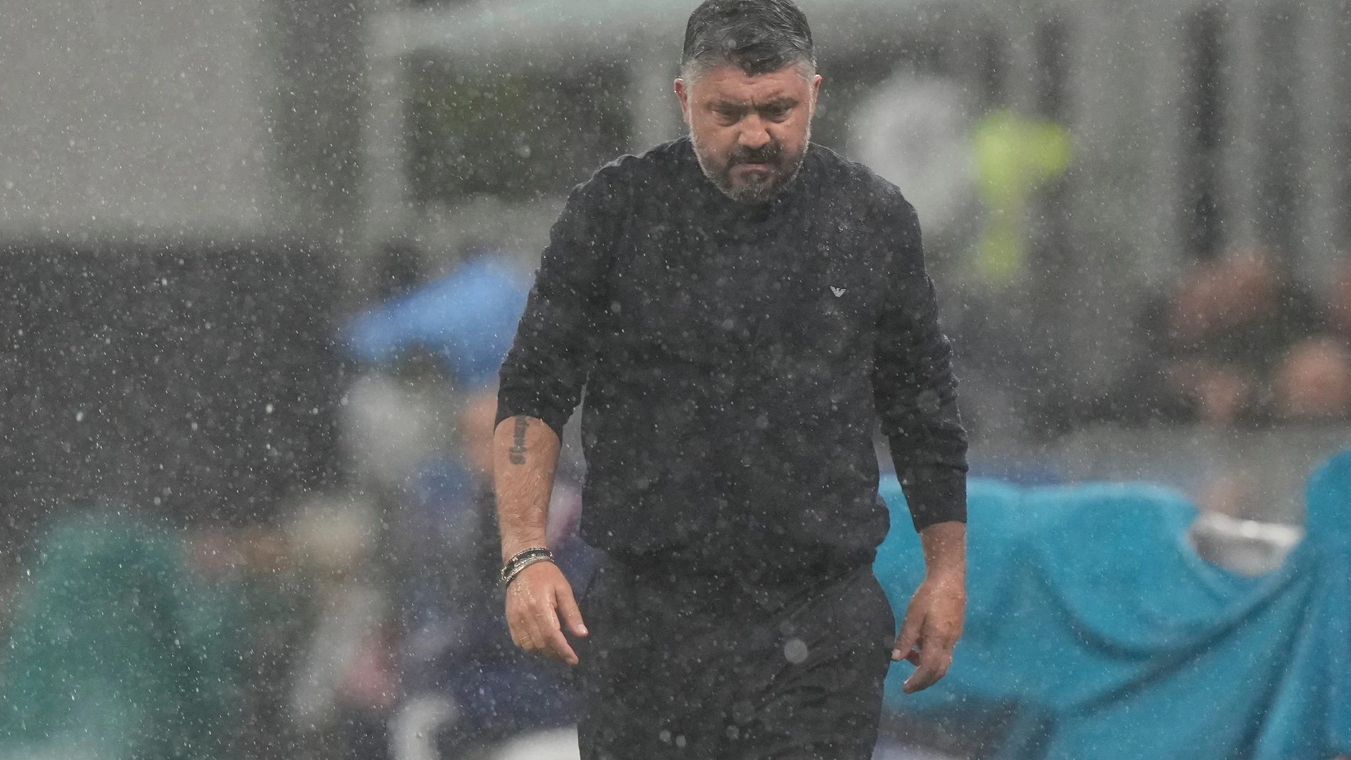 Italy's head coach Gennaro Gattuso walks under the rain before the start of the 2026 World Cup Group I qualifier soccer match between Italy and Norway in Milan, Italy, Sunday, Nov. 16, 2025. (AP Photo/Luca Bruno)