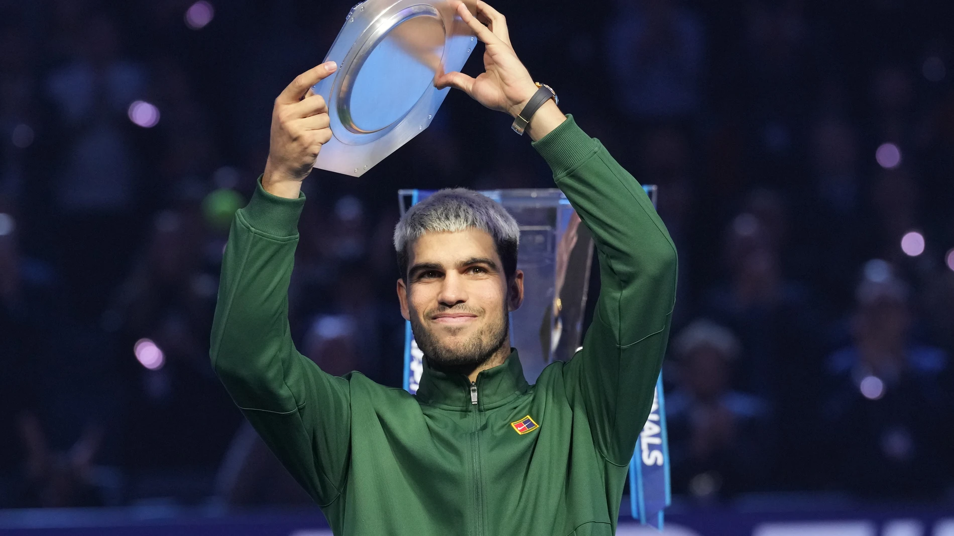 Spain's Carlos Alcaraz holds runners-up trophy after losing the final tennis match of the ATP World Tour Finals against Italy's Jannik Sinner, in Turin, Italy, Sunday, Nov. 16, 2025. (AP Photo/Antonio Calanni)