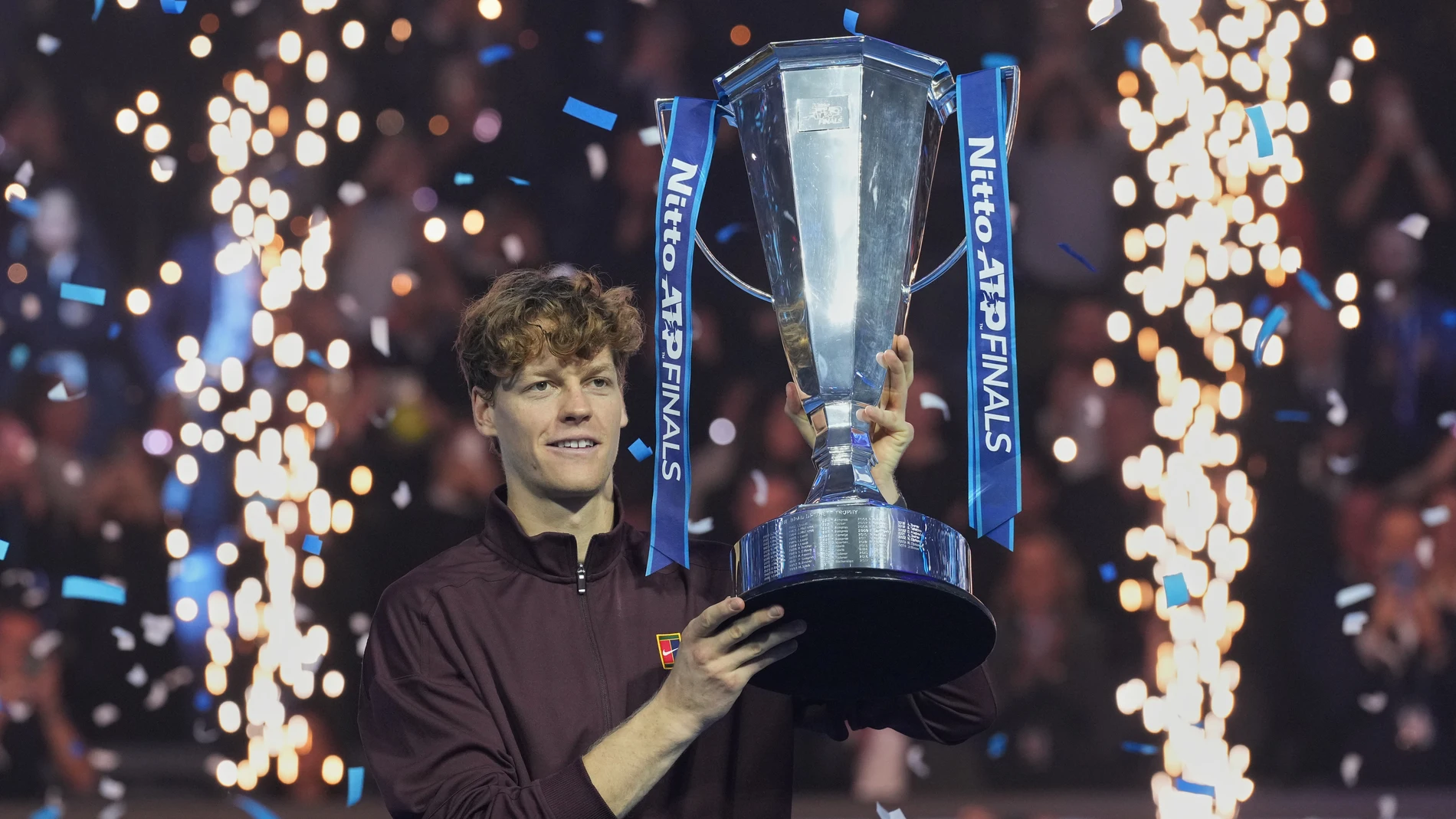 Italy's Jannik Sinner holds the trophy after winning the final tennis match of the ATP World Tour Finals against Spain's Carlos Alcaraz in Turin, Italy, Sunday, Nov. 16, 2025. (AP Photo/Antonio Calanni)