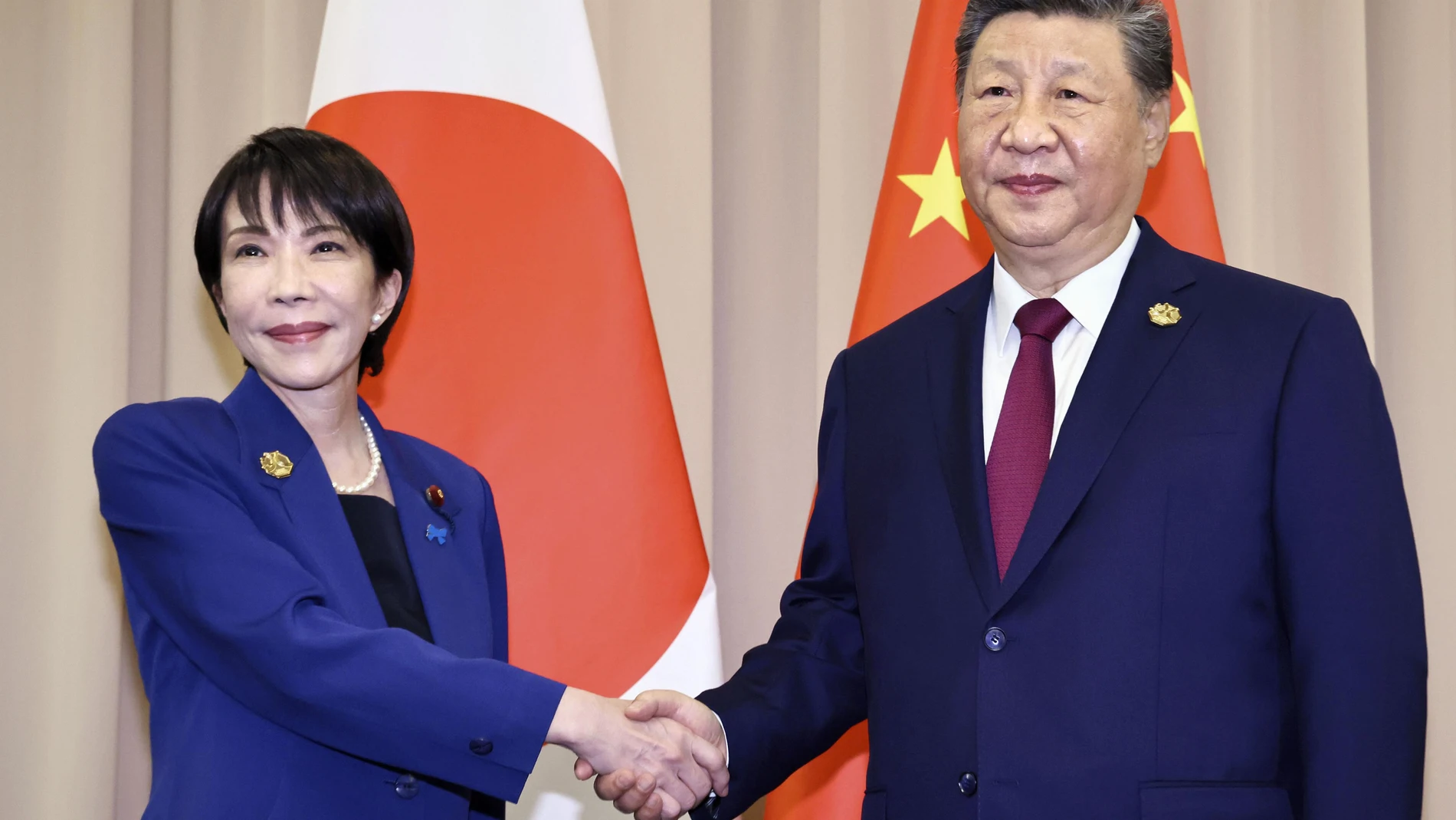 FILE - Chinese President Xi Jinping, right, shakes hands with Japanese Prime Minister Sanae Takaichi ahead of their meeting in Gyeongju, South Korea, Oct. 31, 2025. (Kyodo News via AP, File)