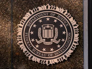 FBI Agent Pride Flag FILE - The seal of the Federal Bureau of Investigation is displayed at its headquarters in Washington, Nov. 18, 2024. (AP Photo/Jose Luis Magana, File)