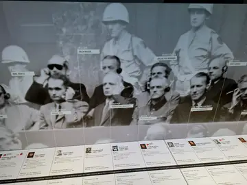 Los juicios de Núremberg: 80 años de la responsabilidad individual de los perpetradores NÚREMBERG, 19/11/2025.- Los 21 jerarcas nazis de mayor rango supervivientes de la II Guerra Mundial se sentaron hace 80 años en el banquillo de la sala 600 del Palacio de Justicia de Núremberg, donde comenzó el principal de los procesos conocidos por el nombre de esta ciudad alemana y que revolucionó el derecho penal internacional, al colocar el foco en la responsabilidad individual. En la imagen, un panel en el museo del Memorium Juicios de Núremberg muestra a los 21 jerarcas nazis que se se...