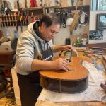 Benigno Marín, el guitarrero que trabaja desde hace 30 años para la marca de Manuel Rodríguez, mide con una regla la altura idónea de la cejuela antes de colocar las cuerdas 