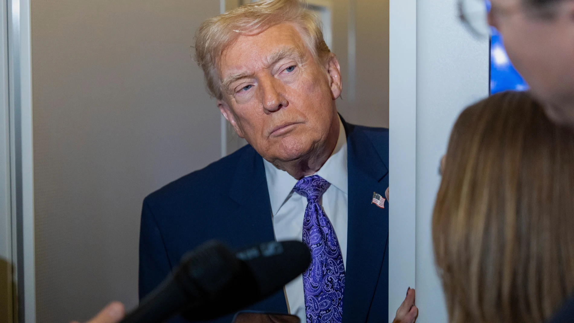 President Donald Trump speaks with reporters while in flight on Air Force One from his Mar-a-Lago estate in Palm Beach, Fla., to Joint Base Andrews, Sunday, Nov. 30, 2025. (AP Photo/Alex Brandon)