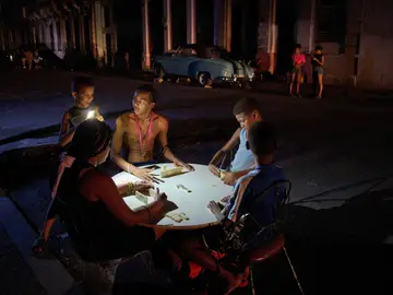 Cuba Energy FILE - People play dominoes on the street during a blackout in Havana, Sept. 10, 2025. (AP Photo/Ramon Espinosa, File)