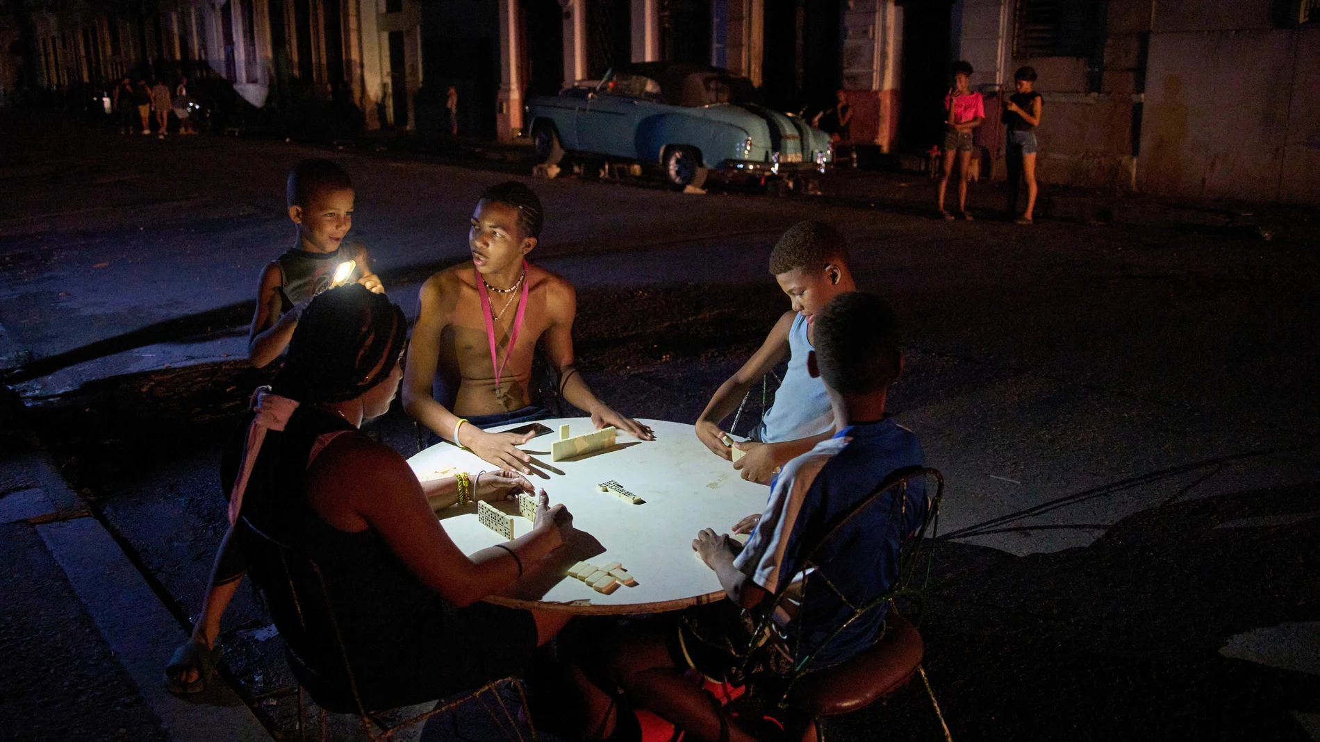 FILE - People play dominoes on the street during a blackout in Havana, Sept. 10, 2025. (AP Photo/Ramon Espinosa, File)