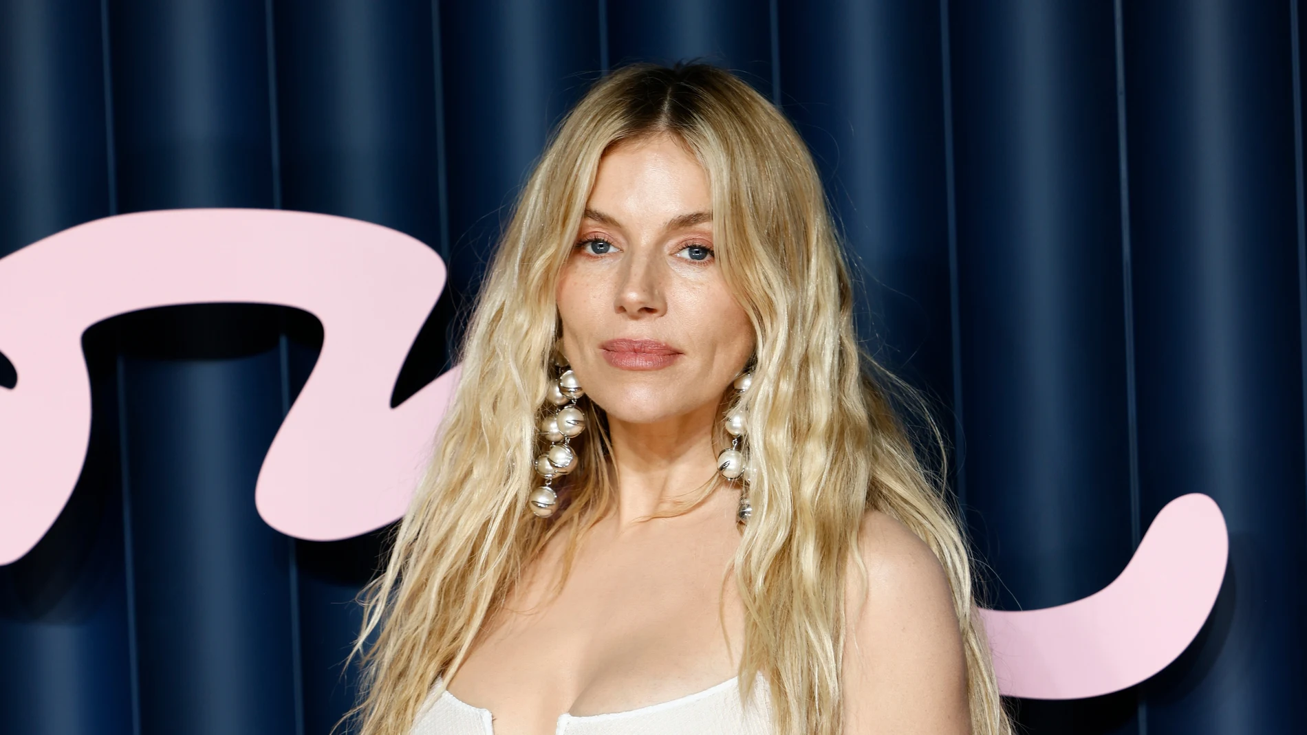 Sienna Miller poses for photographers upon arrival at 'The Fashion Awards 2025' in London, Monday, Dec. 1, 2025. (Photo by Millie Turner/Invision/AP)