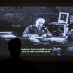 Un espectador contempla a Franco en una de las grabaciones del &laquo;NO-DO&raquo; que forman parte de la muestra de la Filmoteca