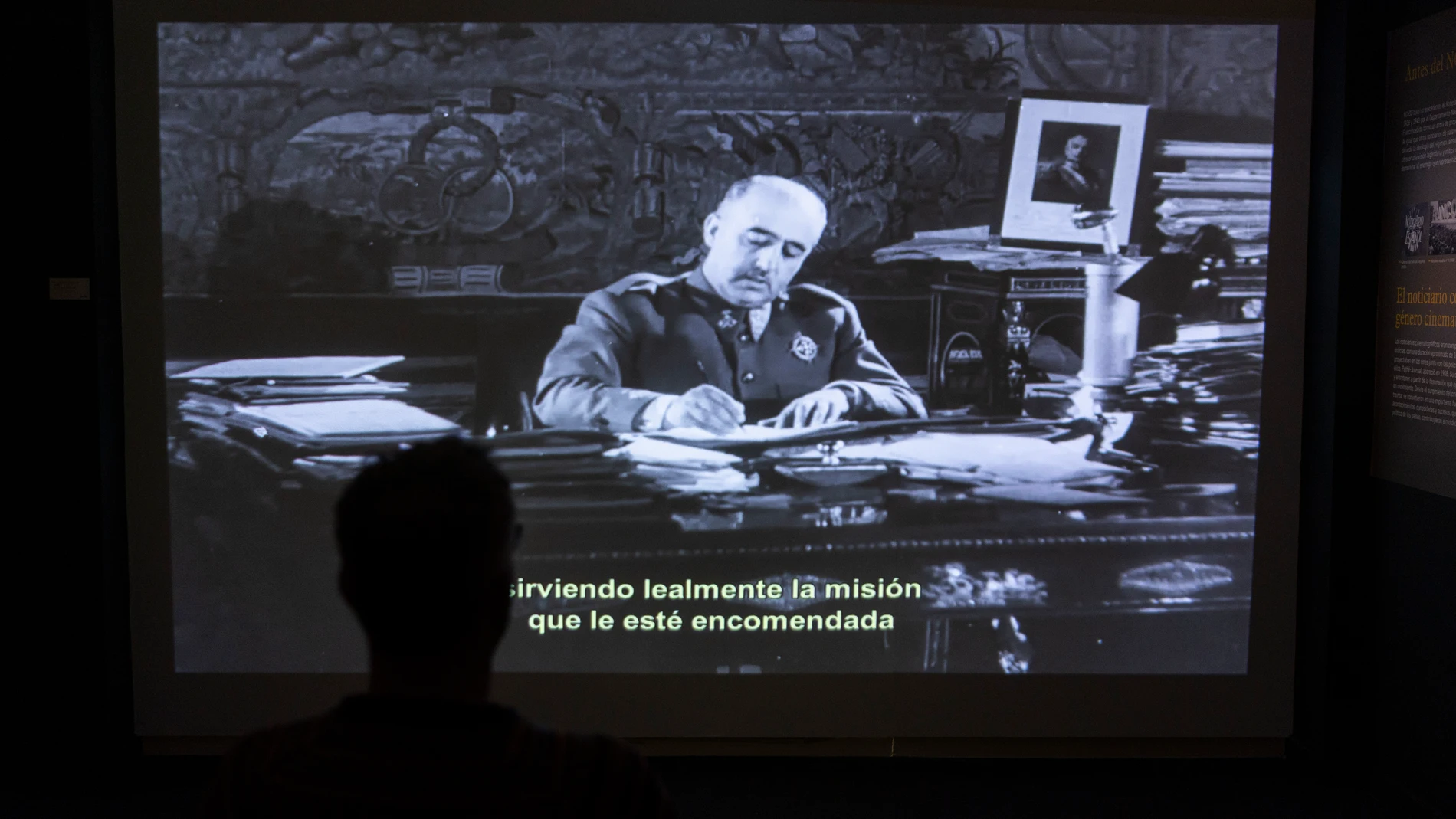 Un espectador contempla a Franco en una de las grabaciones del «NO-DO» que forman parte de la muestra de la Filmoteca