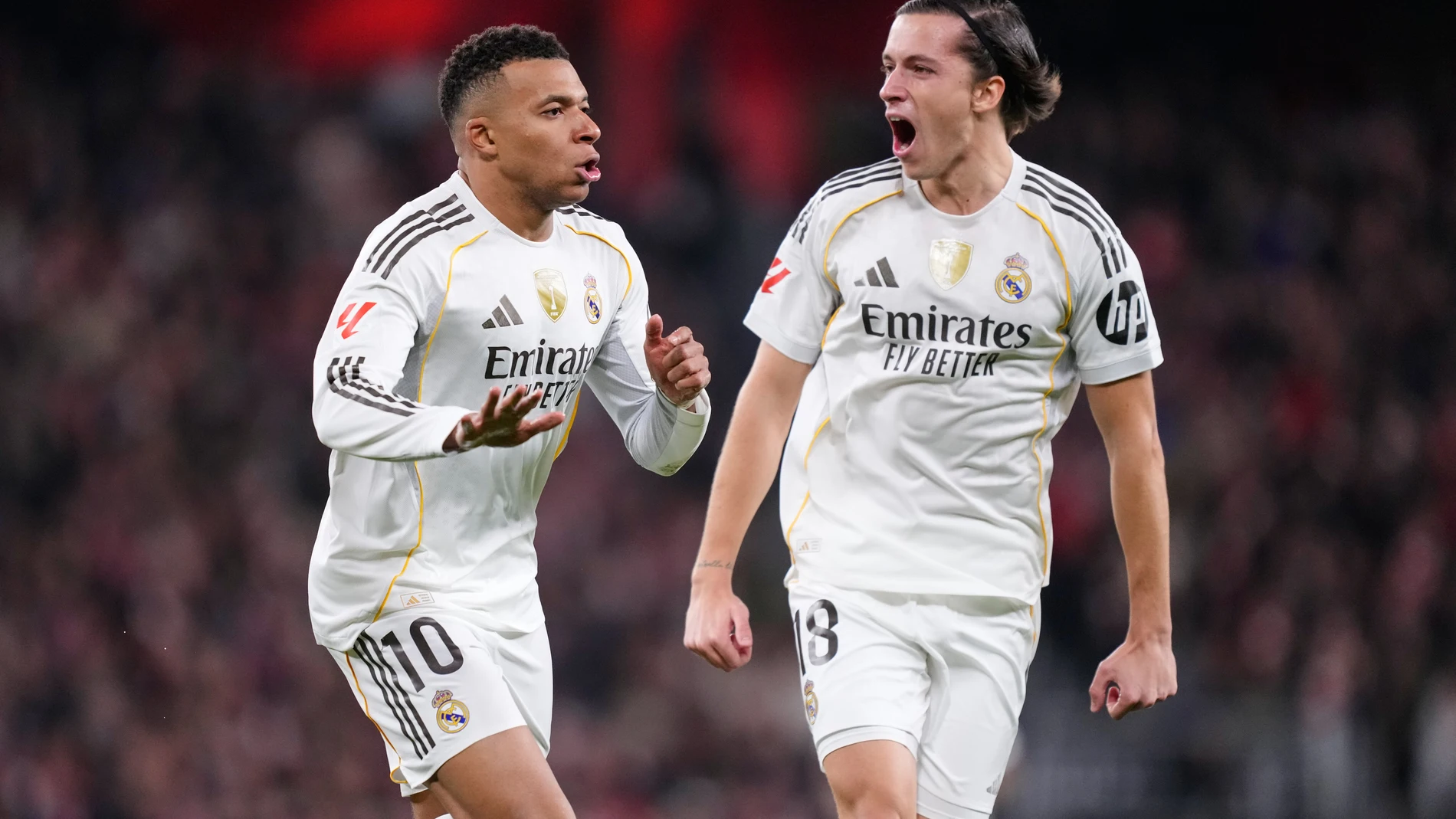 Real Madrid's Kylian Mbappe, left, celebrates with Real Madrid's Alvaro Carreras after scoring his side's opening goal during the Spanish La Liga soccer match between Athletic Club and Real Madrid in Bilbao, Spain, Wednesday, Dec. 3, 2025. (AP Photo/Jose Breton)