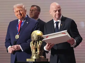 WCup Draw Soccer President Donald Trump receives the FIFA Peace Prize from FIFA President Gianni Infantino during the draw for the 2026 soccer World Cup at the Kennedy Center in Washington, Friday, Dec. 5, 2025. (AP Photo/Jacquelyn Martin)