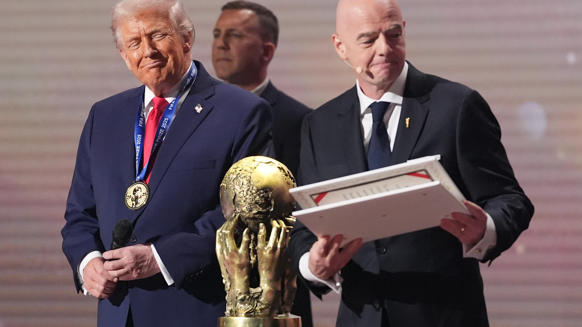 President Donald Trump receives the FIFA Peace Prize from FIFA President Gianni Infantino during the draw for the 2026 soccer World Cup at the Kennedy Center in Washington, Friday, Dec. 5, 2025. (AP Photo/Jacquelyn Martin)