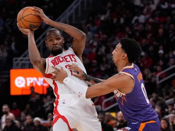 Houston Rockets forward Kevin Durant (7) controls the ball against Phoenix Suns forward Ryan Dunn (0) during the second half of an NBA basketball game in Houston, Friday, Dec. 5, 2025. (AP Photo/Ashley Landis)